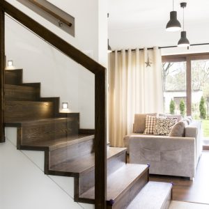 Wooden wide stairs on the first floor in the corridor of big elegant house
